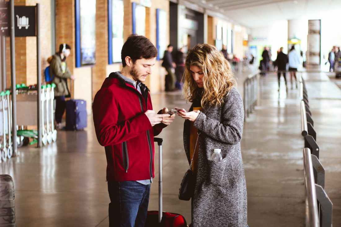 photo of man and woman using their phones